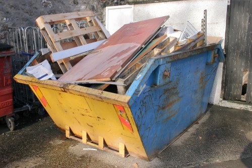 Construction site with builders waste being cleared in Carshalton