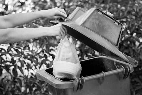 Workers handling builders waste clearance in Carshalton